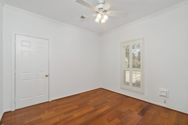 empty room with visible vents, crown molding, baseboards, ceiling fan, and wood finished floors