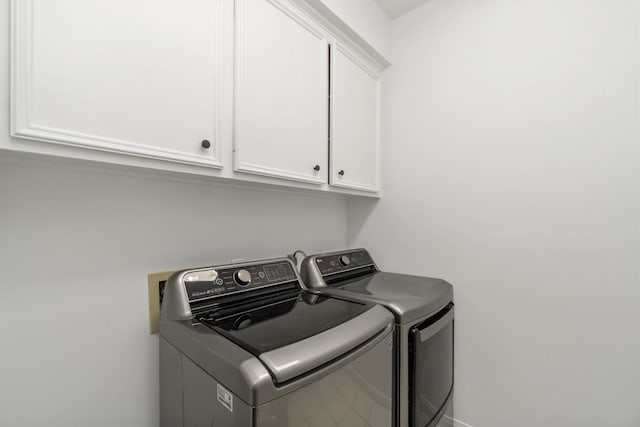 laundry area with cabinet space and independent washer and dryer