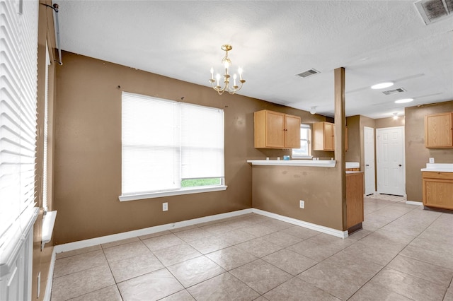 kitchen featuring a notable chandelier, a healthy amount of sunlight, and visible vents