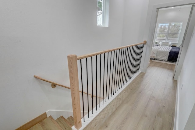 interior space featuring a wealth of natural light, baseboards, and wood finished floors