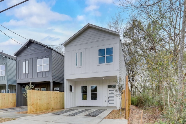 view of front of house with fence and board and batten siding