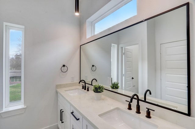 full bath featuring double vanity and a sink