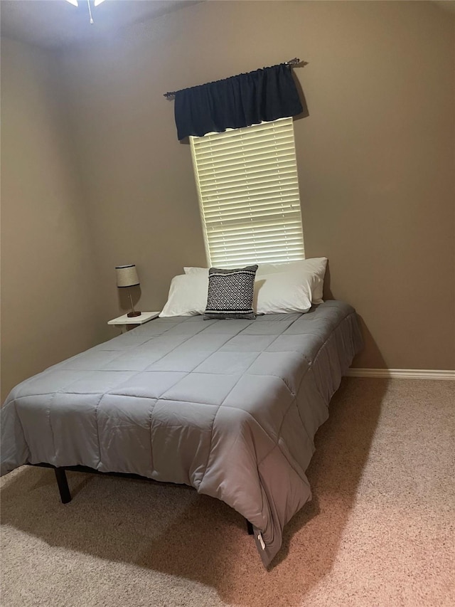 bedroom with baseboards and carpet floors