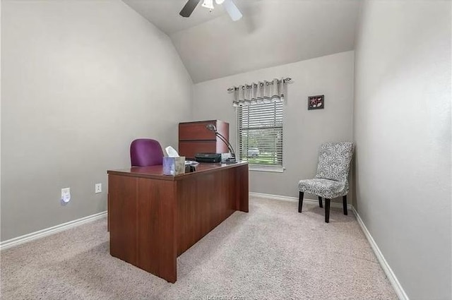 home office featuring baseboards, lofted ceiling, light carpet, and ceiling fan