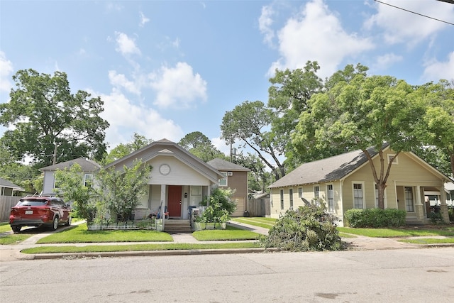 bungalow featuring driveway and a front yard