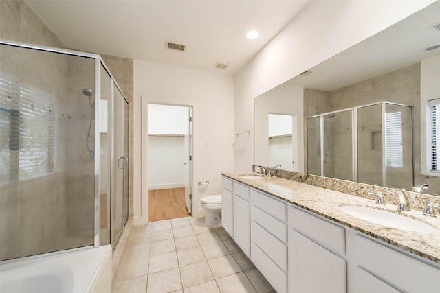 full bathroom with tile patterned flooring, a stall shower, and a sink