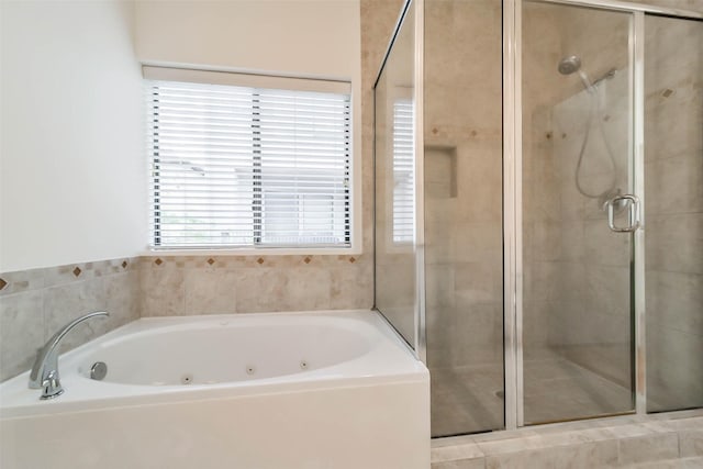 full bathroom featuring a shower stall and a whirlpool tub