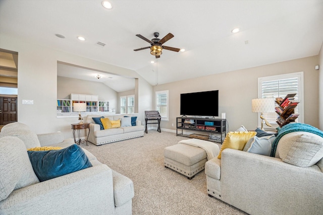 living area with visible vents, baseboards, ceiling fan, vaulted ceiling, and carpet flooring