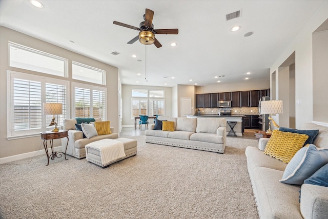 living area with visible vents, recessed lighting, baseboards, and ceiling fan