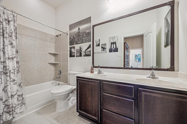 bathroom with double vanity, toilet, shower / bath combo, and a sink