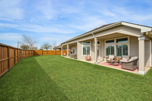 back of house featuring a yard, a patio, and a fenced backyard