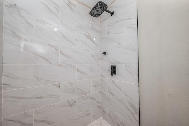 bathroom with tiled shower