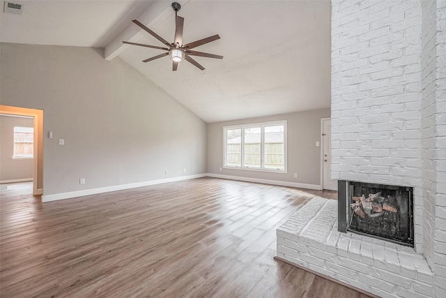 unfurnished living room with visible vents, beam ceiling, a ceiling fan, wood finished floors, and a fireplace