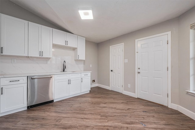 kitchen featuring a sink, stainless steel dishwasher, wood finished floors, and white cabinets