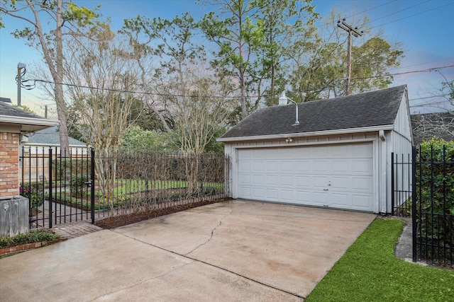 detached garage featuring fence