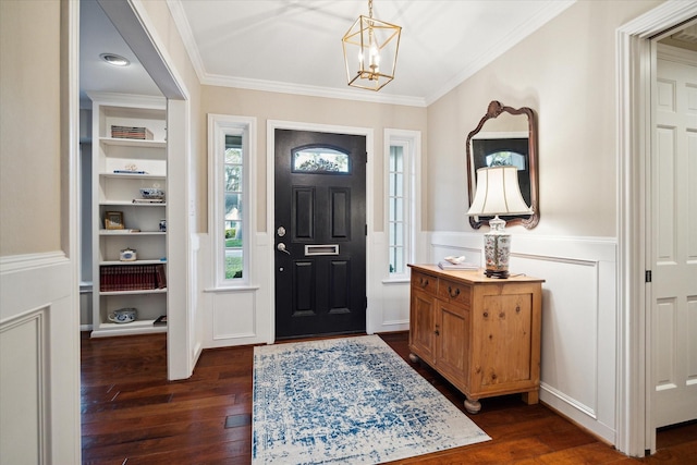 entryway with ornamental molding, wainscoting, an inviting chandelier, a decorative wall, and dark wood-style flooring