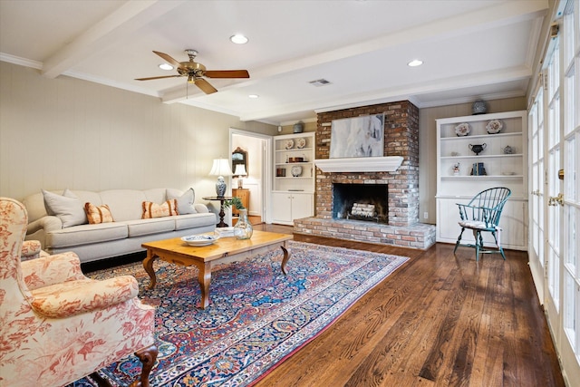 living room featuring beam ceiling, crown molding, ceiling fan, and wood finished floors