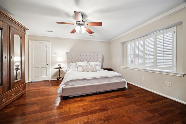 bedroom featuring baseboards, wood-type flooring, visible vents, and crown molding