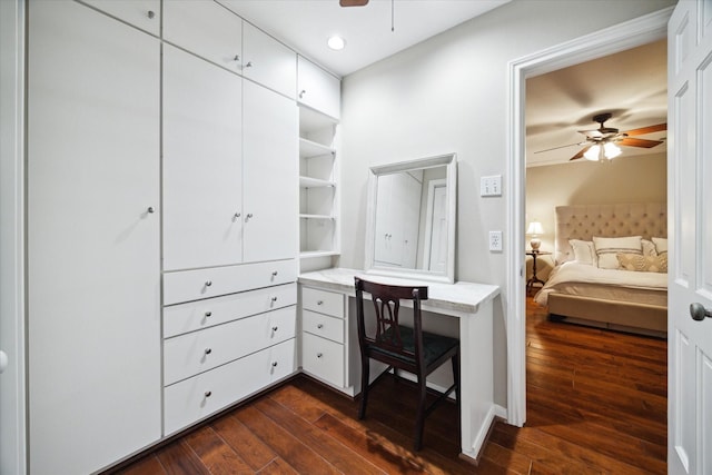 interior space featuring dark wood-type flooring and ceiling fan