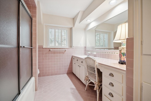 bathroom featuring tile patterned floors, a wainscoted wall, recessed lighting, tile walls, and vanity