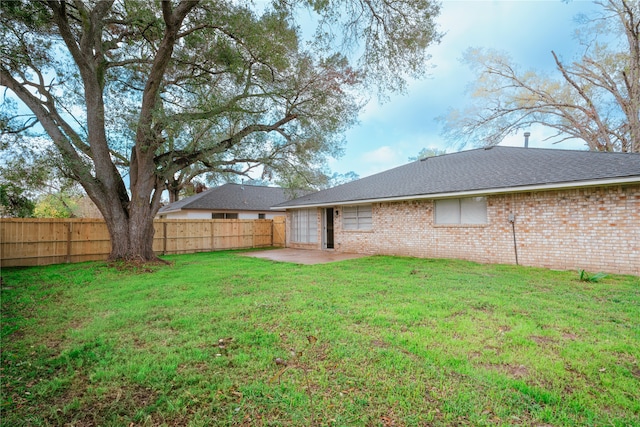 view of yard with a patio and fence