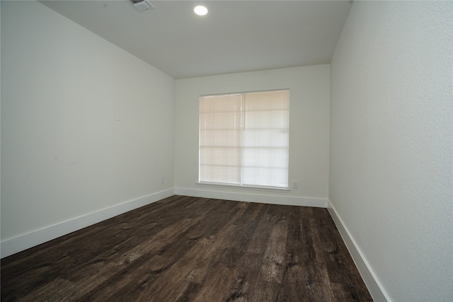 unfurnished room featuring visible vents, recessed lighting, baseboards, and dark wood-style flooring