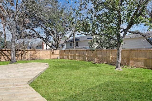 view of yard featuring a deck and fence