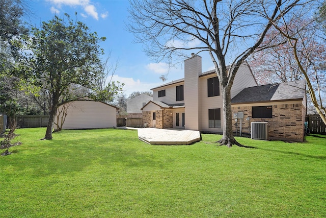 view of yard with a fenced backyard, cooling unit, a storage shed, an outdoor structure, and a wooden deck