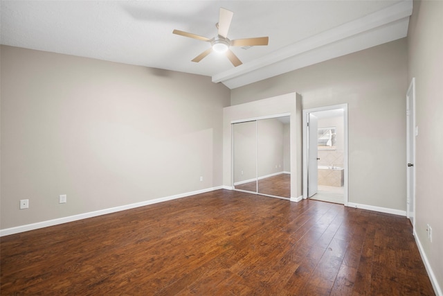 unfurnished bedroom featuring baseboards, lofted ceiling, ceiling fan, a closet, and wood-type flooring