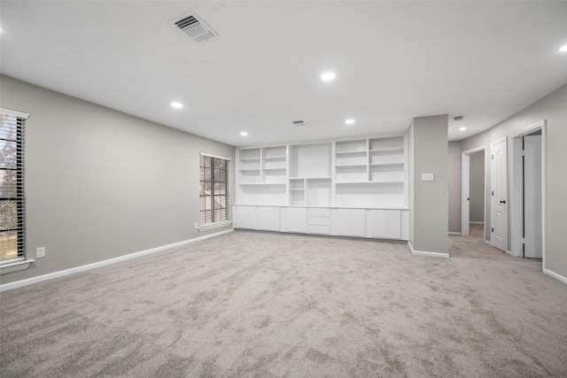 unfurnished living room with recessed lighting, visible vents, light carpet, and baseboards