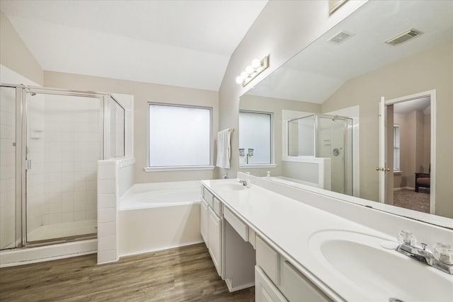 full bathroom with a sink, visible vents, and vaulted ceiling