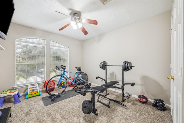 workout room with baseboards, carpet, and ceiling fan