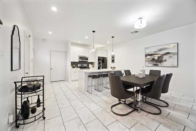 dining room featuring recessed lighting, visible vents, marble finish floor, and baseboards