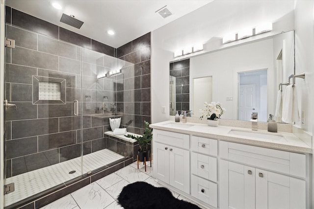 bathroom with a shower stall, marble finish floor, and a sink