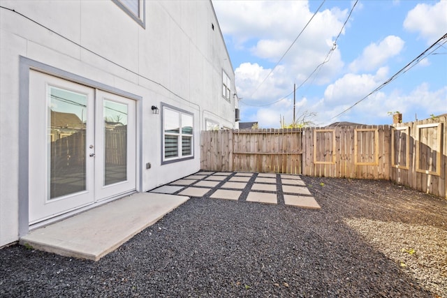 view of yard featuring french doors, a patio, and fence