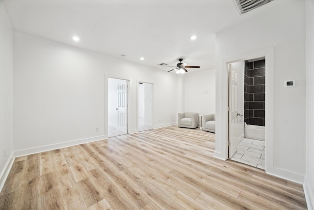 interior space with recessed lighting, visible vents, wood finished floors, and ensuite bathroom