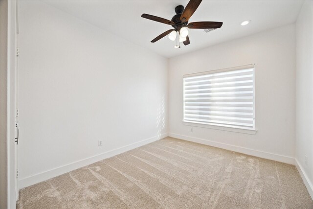 carpeted spare room with recessed lighting, a ceiling fan, and baseboards