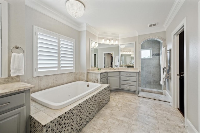 bathroom featuring visible vents, crown molding, a tile shower, a bath, and vanity