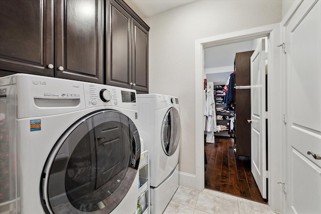 laundry area with cabinet space and independent washer and dryer