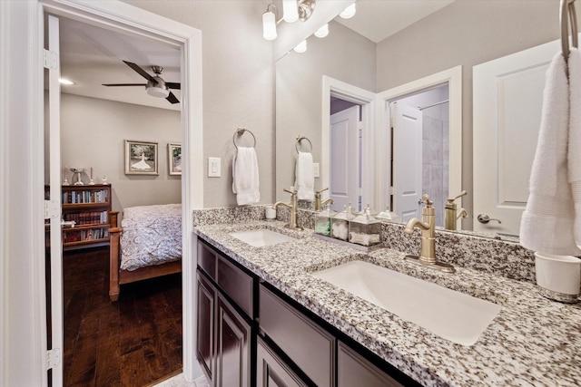 ensuite bathroom with wood finished floors, a ceiling fan, ensuite bathroom, and a sink