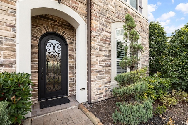 property entrance with stone siding