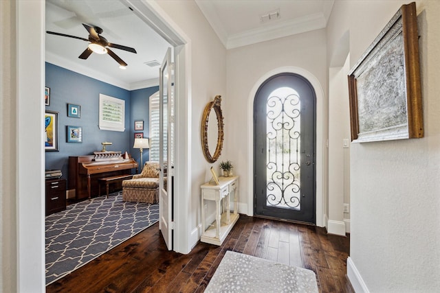 foyer featuring ceiling fan, dark wood-style floors, visible vents, and ornamental molding