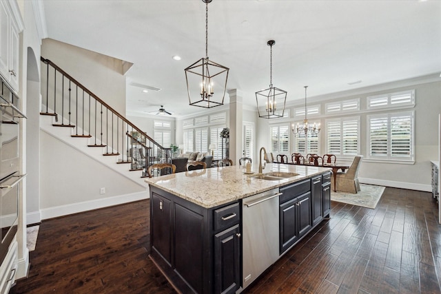 kitchen with dark wood-style floors, dishwasher, baseboards, and a sink