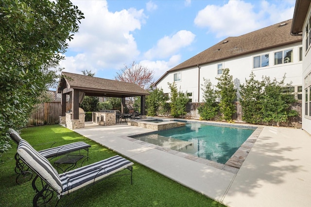 view of pool with an outdoor kitchen, a yard, a fenced backyard, a gazebo, and a patio area