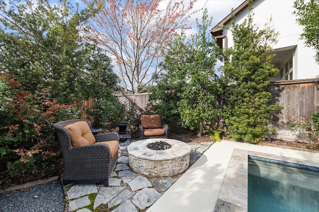 view of patio featuring a fenced backyard, a fenced in pool, and an outdoor fire pit