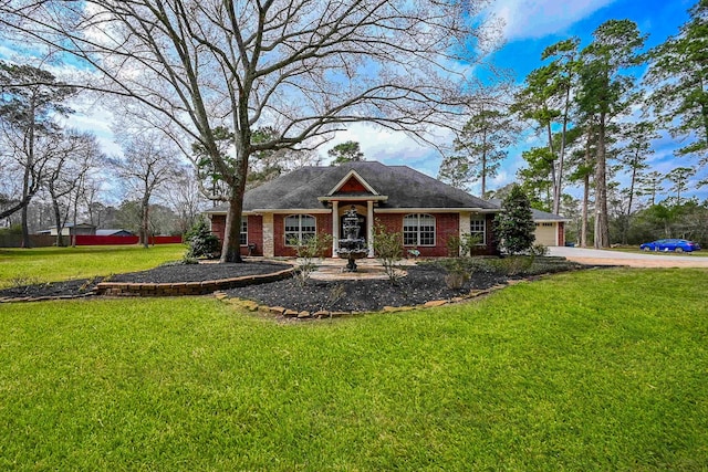 view of front of property with a garage, driveway, brick siding, and a front yard