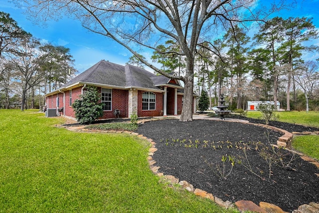 view of side of property featuring brick siding and a lawn