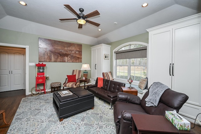 living room with baseboards, ceiling fan, vaulted ceiling, recessed lighting, and wood finished floors