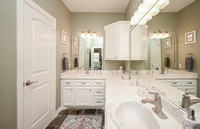 ensuite bathroom featuring double vanity, ensuite bathroom, and a sink