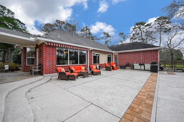 rear view of house with brick siding, an outdoor living space, a patio, and fence